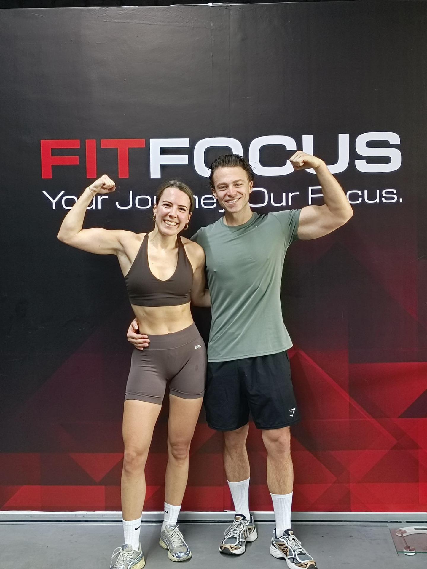 FIT FOCUS members in front of brand wall